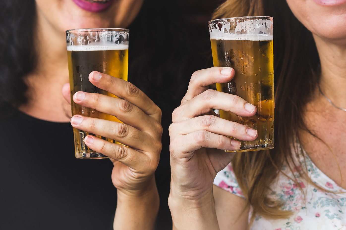 two glasses in two hands